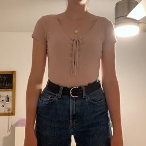 Light pink/ nude body suit with a lace up front.